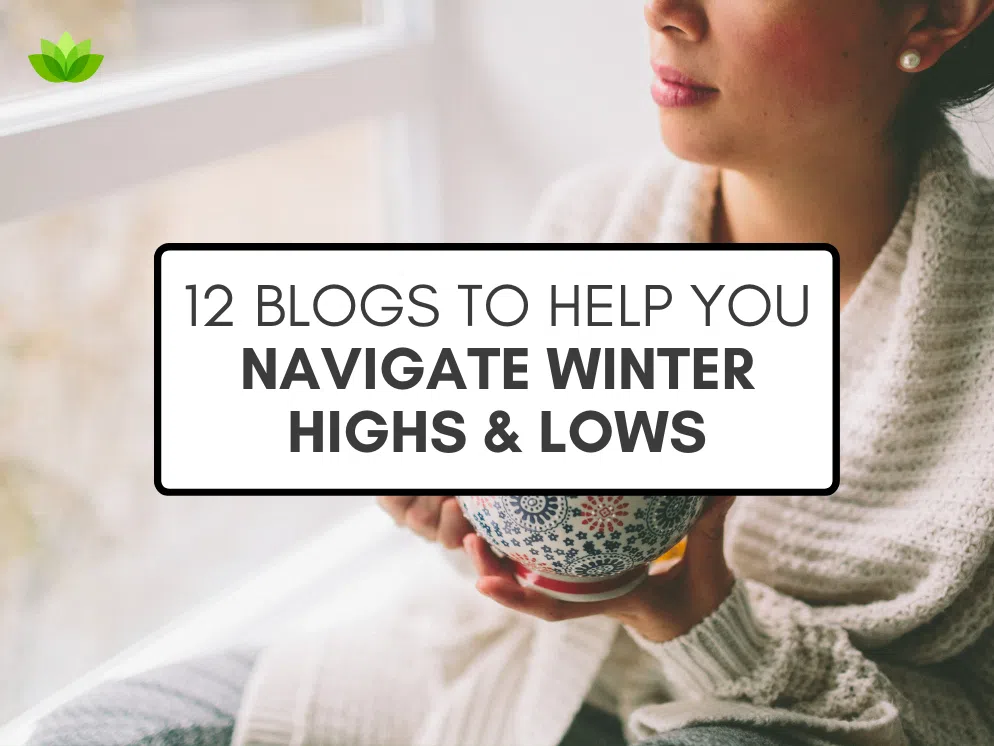 "12 Blogs to Help You Navigate Winter Highs & Lows" in black text inside a white text box with a black border, over a stock photo of a of woman holding a mug looking out a window.