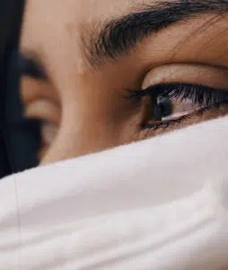 A stock photo close up of a dark haired woman's eyes.