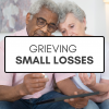 An elderly man and woman sitting close together on a couch holding tea lights behind a white box with black letters that read "Grieving small losses"